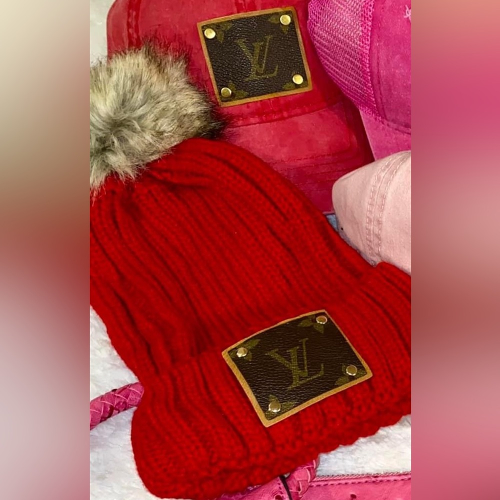 Upcycled LV toboggan with removable pom.